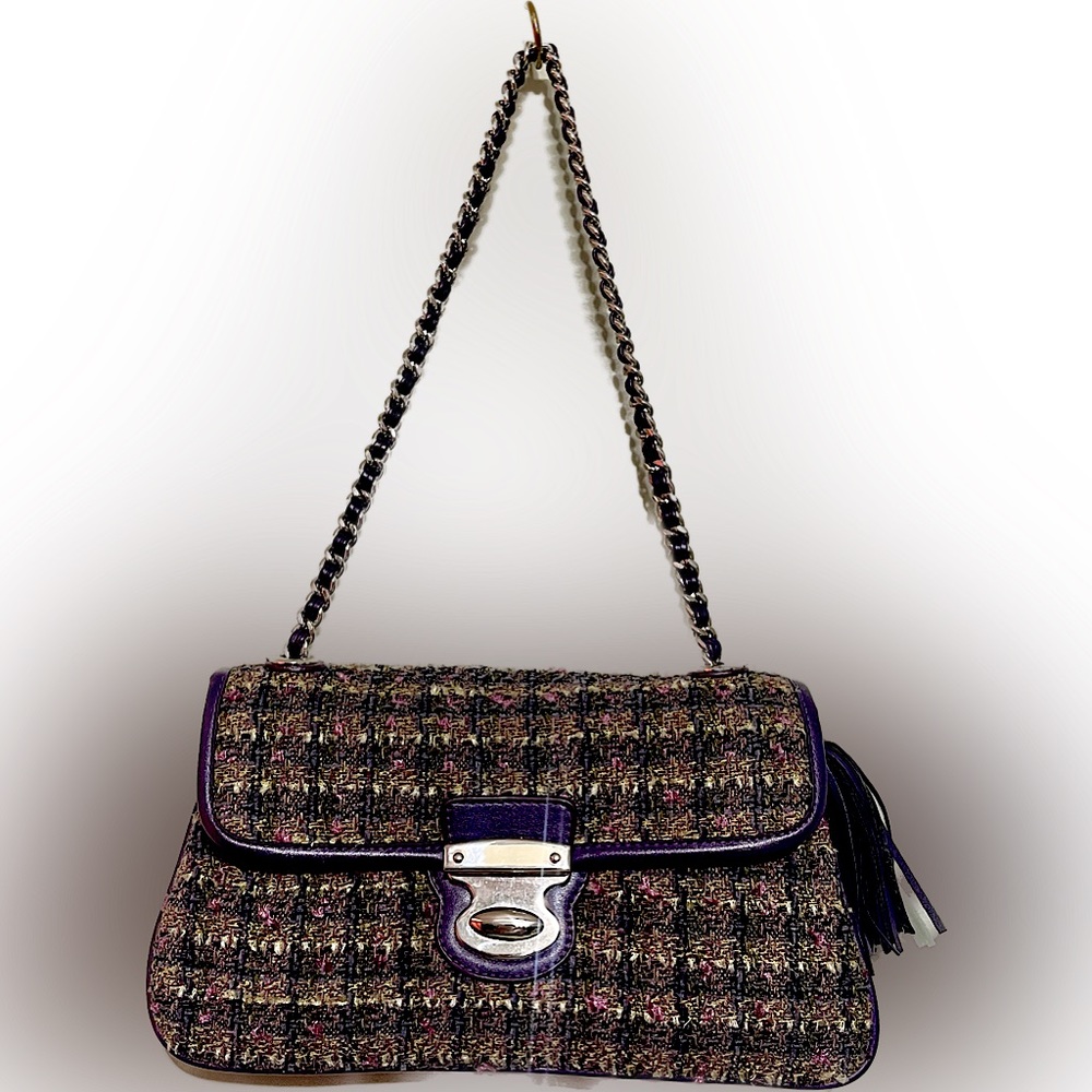 Purse with leather threaded through chain shoulder strap.